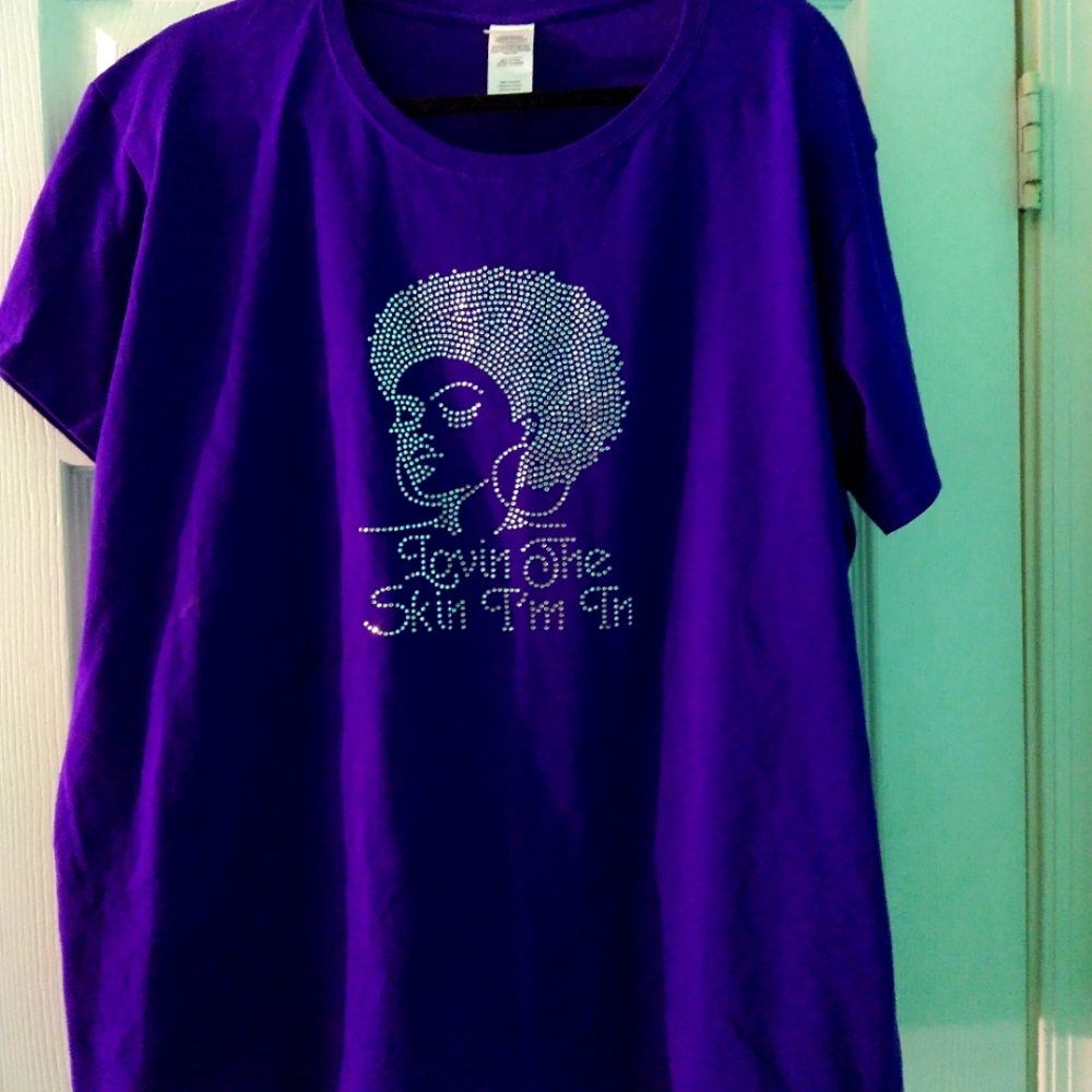 Purple t-shirt with woman figure and rhinestones.